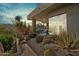 Inviting backyard patio with desert landscaping, covered seating area, and mountain views at 38199 N Tranquil Way, Carefree, AZ 85377