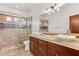 The bathroom offers dual sinks, granite counters, decorative tile and a glass shower at 38199 N Tranquil Way, Carefree, AZ 85377