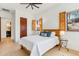 Bedroom featuring white walls, hardwood floors, ceiling fan, and exterior view through window at 38199 N Tranquil Way, Carefree, AZ 85377