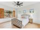 Bright main bedroom offers decorative shutters, wood floors, ceiling fan, and a view at 38199 N Tranquil Way, Carefree, AZ 85377