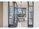 Grand entryway with tile floors, modern light fixture and picturesque desert views at 38199 N Tranquil Way, Carefree, AZ 85377
