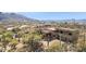 Desert home nestled in lush landscaping with views of mountains in the distance at 38199 N Tranquil Way, Carefree, AZ 85377
