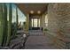 Inviting front entrance with stone accents, desert landscaping, and a modern glass door at 38199 N Tranquil Way, Carefree, AZ 85377