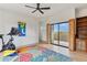 Home gym with exercise equipment, floral rug, sliding glass doors to balcony, and exterior view at 38199 N Tranquil Way, Carefree, AZ 85377
