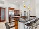 Spacious kitchen with a large center island, granite countertops, and stainless steel refrigerator at 38199 N Tranquil Way, Carefree, AZ 85377