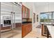 Modern kitchen featuring stainless steel refrigerator, custom cabinetry, and granite countertops at 38199 N Tranquil Way, Carefree, AZ 85377
