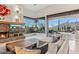 Bright living room boasts a stone fireplace, large windows, and seamless indoor-outdoor flow to the desert landscape at 38199 N Tranquil Way, Carefree, AZ 85377