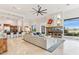Open living room features a stone fireplace, views of the backyard, and an open floor plan at 38199 N Tranquil Way, Carefree, AZ 85377
