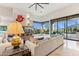 Inviting living room with stunning views, a stone fireplace, and plush sofa at 38199 N Tranquil Way, Carefree, AZ 85377