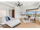 Bright bedroom with hardwood flooring, white walls, a cozy bed, and access to desert views at 38199 N Tranquil Way, Carefree, AZ 85377