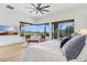 Relaxing main bedroom featuring desert views, hardwood floors, comfortable furniture, and scenic outdoor access at 38199 N Tranquil Way, Carefree, AZ 85377