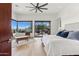 Spacious main bedroom with a large window, scenic views, hardwood flooring, and stylish decor at 38199 N Tranquil Way, Carefree, AZ 85377