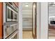 Walk-in pantry with abundant shelving, located next to stainless steel oven and microwave at 38199 N Tranquil Way, Carefree, AZ 85377