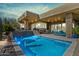 Inviting backyard pool with a stone accent wall and modern outdoor furniture, perfect for relaxation at 38199 N Tranquil Way, Carefree, AZ 85377
