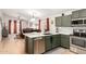 Well-appointed kitchen with modern appliances, green cabinetry, and an open concept design at 4076 E Silverbell Rd, San Tan Valley, AZ 85143
