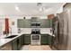 Updated kitchen with sleek stainless steel appliances and painted cabinets at 4076 E Silverbell Rd, San Tan Valley, AZ 85143