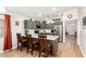 Stylish kitchen with olive green cabinets, stainless steel appliances, and a breakfast bar at 4076 E Silverbell Rd, San Tan Valley, AZ 85143