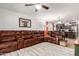 Open-concept living room flowing from kitchen with a plush sectional and ample lighting at 4076 E Silverbell Rd, San Tan Valley, AZ 85143