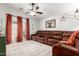 Cozy living room with plush sectional, ceiling fan, and sliding glass door at 4076 E Silverbell Rd, San Tan Valley, AZ 85143