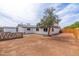 Expansive dirt backyard featuring a white house with black trim and a mature tree at 4109 N 30Th Ave, Phoenix, AZ 85017