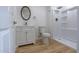 Clean, renovated bathroom with a new vanity, toilet, and a bright shower at 4109 N 30Th Ave, Phoenix, AZ 85017