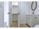 Bathroom with a white vanity, modern sink, and wooden-framed mirror next to the closet at 4109 N 30Th Ave, Phoenix, AZ 85017