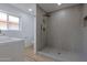 Updated bathroom features a walk-in shower with custom tilework, dual shower heads, and a window at 4109 N 30Th Ave, Phoenix, AZ 85017