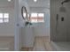 Modern bathroom boasts dual sinks, wooden-framed mirrors, and a glass-enclosed shower with sleek hardware at 4109 N 30Th Ave, Phoenix, AZ 85017