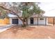 Front exterior with freshly painted white brick, new garage door, and drought-tolerant landscaping at 4109 N 30Th Ave, Phoenix, AZ 85017