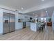 Open-concept kitchen with stainless steel appliances, an island, and a seamless flow to living and dining spaces at 4109 N 30Th Ave, Phoenix, AZ 85017