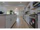 Well-equipped kitchen with stainless steel appliances, white cabinetry, and a seamless connection to the living space at 4109 N 30Th Ave, Phoenix, AZ 85017