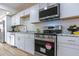 Modern kitchen with stainless steel oven, stylish white cabinets, and granite countertops with designer touches at 4109 N 30Th Ave, Phoenix, AZ 85017