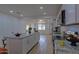 Modern kitchen featuring white cabinets, stainless steel appliances, and an open layout to the living areas at 4109 N 30Th Ave, Phoenix, AZ 85017