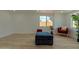 Cozy living room features wood floors, neutral walls, large window, and comfortable seating at 4109 N 30Th Ave, Phoenix, AZ 85017