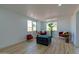 Bright living room features wood floors, neutral walls, large windows, and comfortable seating at 4109 N 30Th Ave, Phoenix, AZ 85017