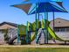 A playground structure featuring blue, gray and green slides and climbing features for children at 4315 W Hannah St, San Tan Valley, AZ 85144