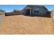 View of the home's spacious backyard with dirt landscaping and partial views of the home's rear exterior at 4364 W Hannah St, San Tan Valley, AZ 85144