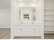 Modern bathroom featuring double sinks, large mirror, and built-in shelves at 4364 W Hannah St, San Tan Valley, AZ 85144