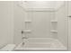 This bright bathroom features a white shower-tub combo with wall shelves at 4364 W Hannah St, San Tan Valley, AZ 85144