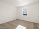 This bright bedroom features neutral carpeting and a window with blinds at 4364 W Hannah St, San Tan Valley, AZ 85144