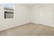 A bright bedroom features neutral carpeting, a window with blinds and a double door closet at 4364 W Hannah St, San Tan Valley, AZ 85144
