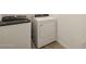 This laundry room features a white dryer and washer combo set on tile flooring at 4364 W Hannah St, San Tan Valley, AZ 85144
