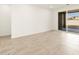 A brightly lit living area featuring tile flooring, large windows, and patio access at 4364 W Hannah St, San Tan Valley, AZ 85144