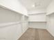 Spacious walk-in closet with carpet flooring and ample shelving and racks for clothing storage at 4364 W Hannah St, San Tan Valley, AZ 85144