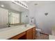 Bright bathroom featuring a large mirror, vanity, and a separate shower at 45068 W Alamendras St, Maricopa, AZ 85139