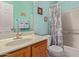 Bathroom boasts a shower with patterned curtain and a vanity with chrome faucet at 45068 W Alamendras St, Maricopa, AZ 85139