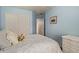Bedroom featuring a large closet, blue walls, and an inviting atmosphere for relaxation and rest at 45068 W Alamendras St, Maricopa, AZ 85139
