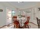 Sunny breakfast nook with a table, four chairs, and a sliding glass door at 45068 W Alamendras St, Maricopa, AZ 85139