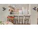 Open kitchen area with bar stool seating and a view into the breakfast nook at 45068 W Alamendras St, Maricopa, AZ 85139