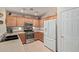 This kitchen is equipped with stainless steel appliances, wood cabinets, and a spacious refrigerator at 45068 W Alamendras St, Maricopa, AZ 85139